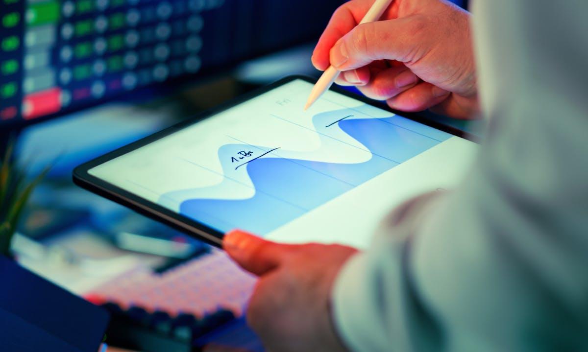 Professional analyzing data charts on a tablet