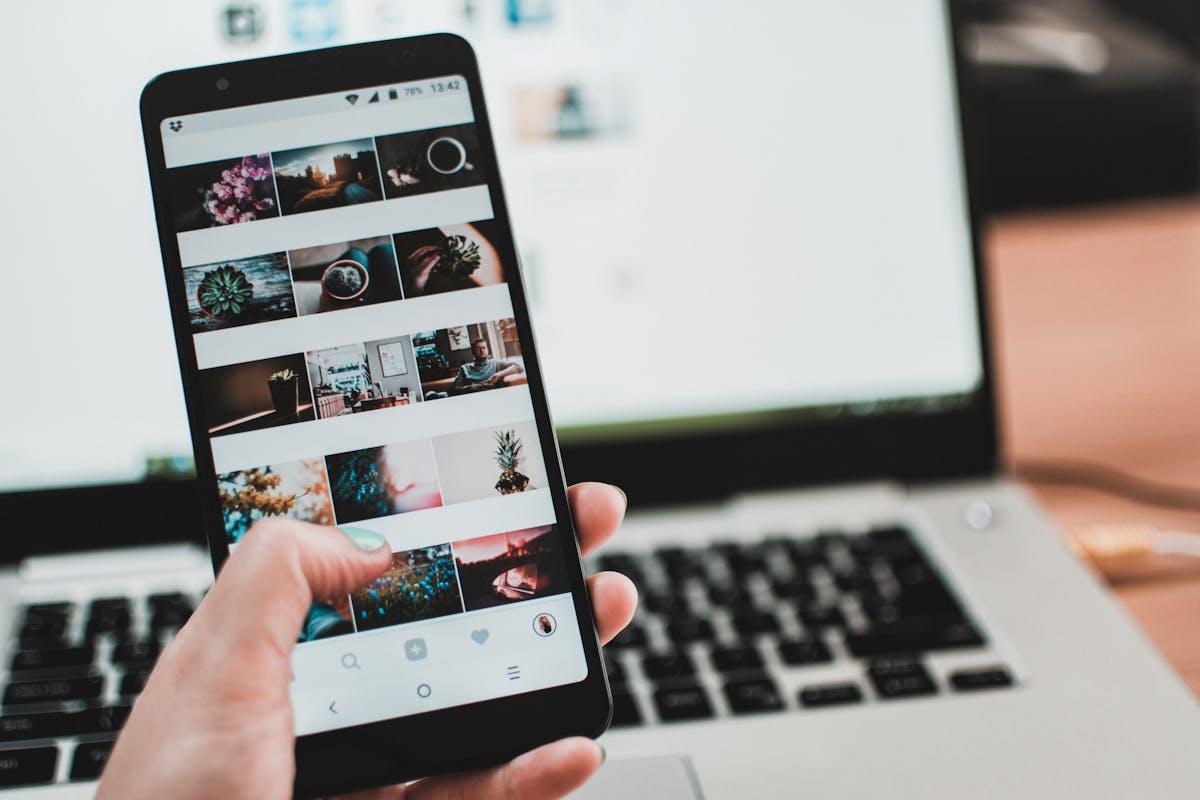 Smartphone displaying social media feed with user-generated content and engagement