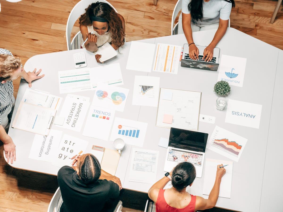Team collaborating on marketing strategies around a white table