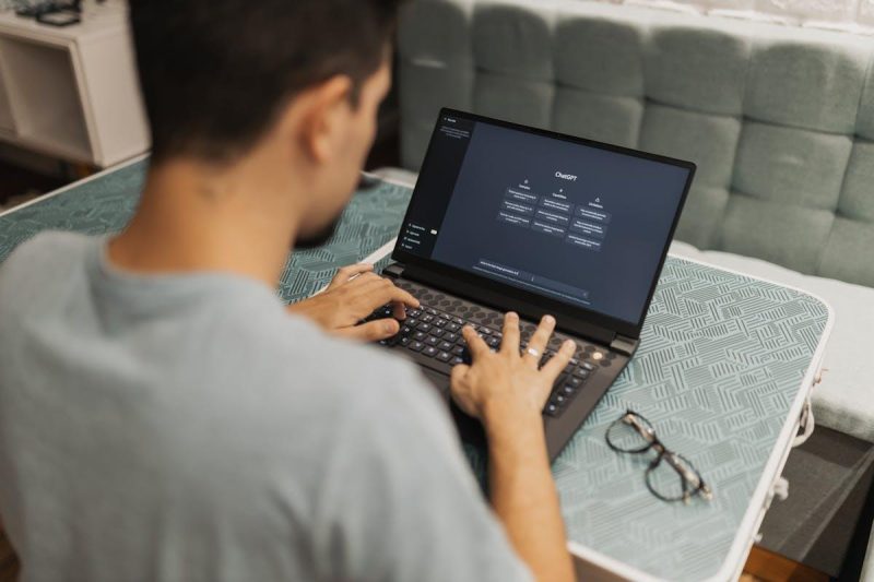 Person using an AI writing assistant on a laptop for social media content creation