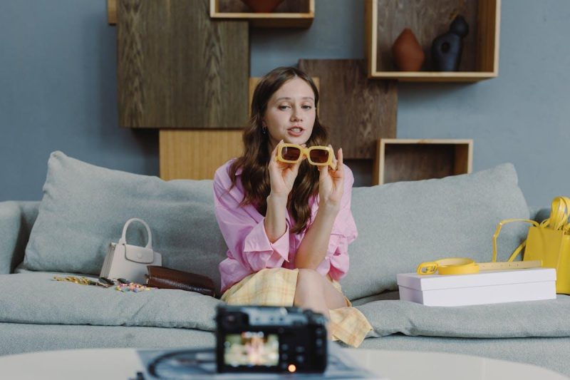 Young woman recording video blog content with smartphone