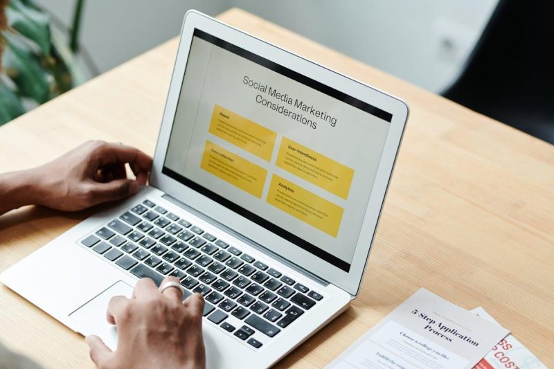 Person using laptop to review social media marketing strategies