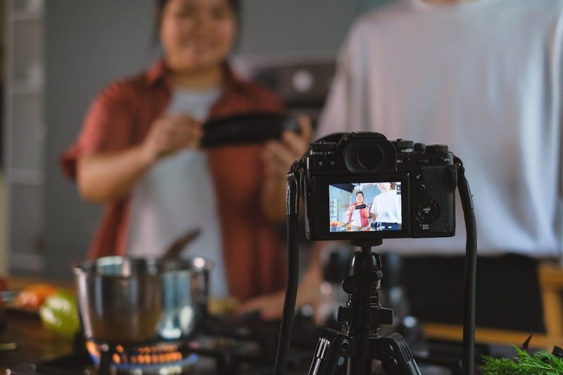 Person setting up smartphone on tripod