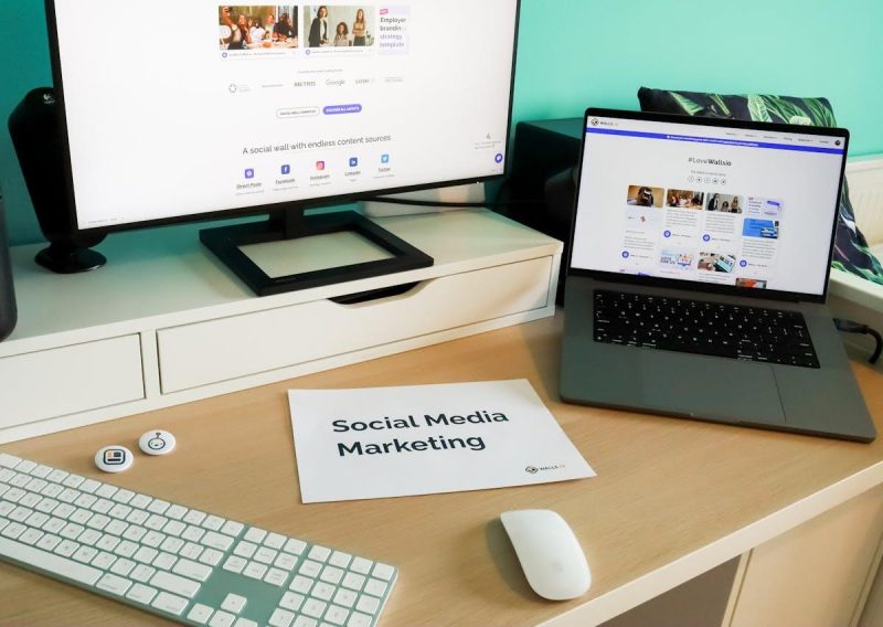 Stylish workspace with laptop and monitor for social media marketing
