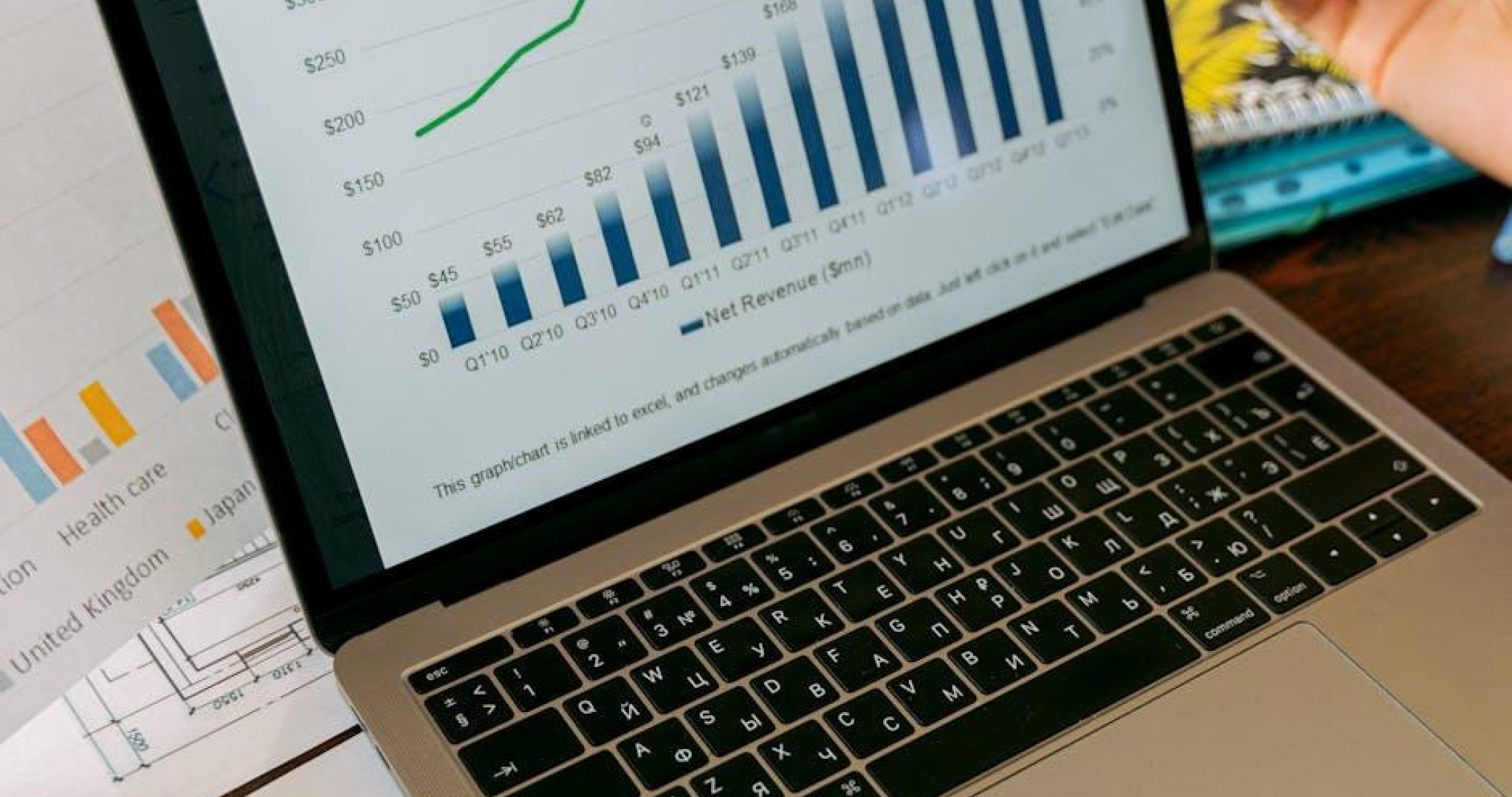 Laptop displaying business analytics and revenue charts, representing social media metrics