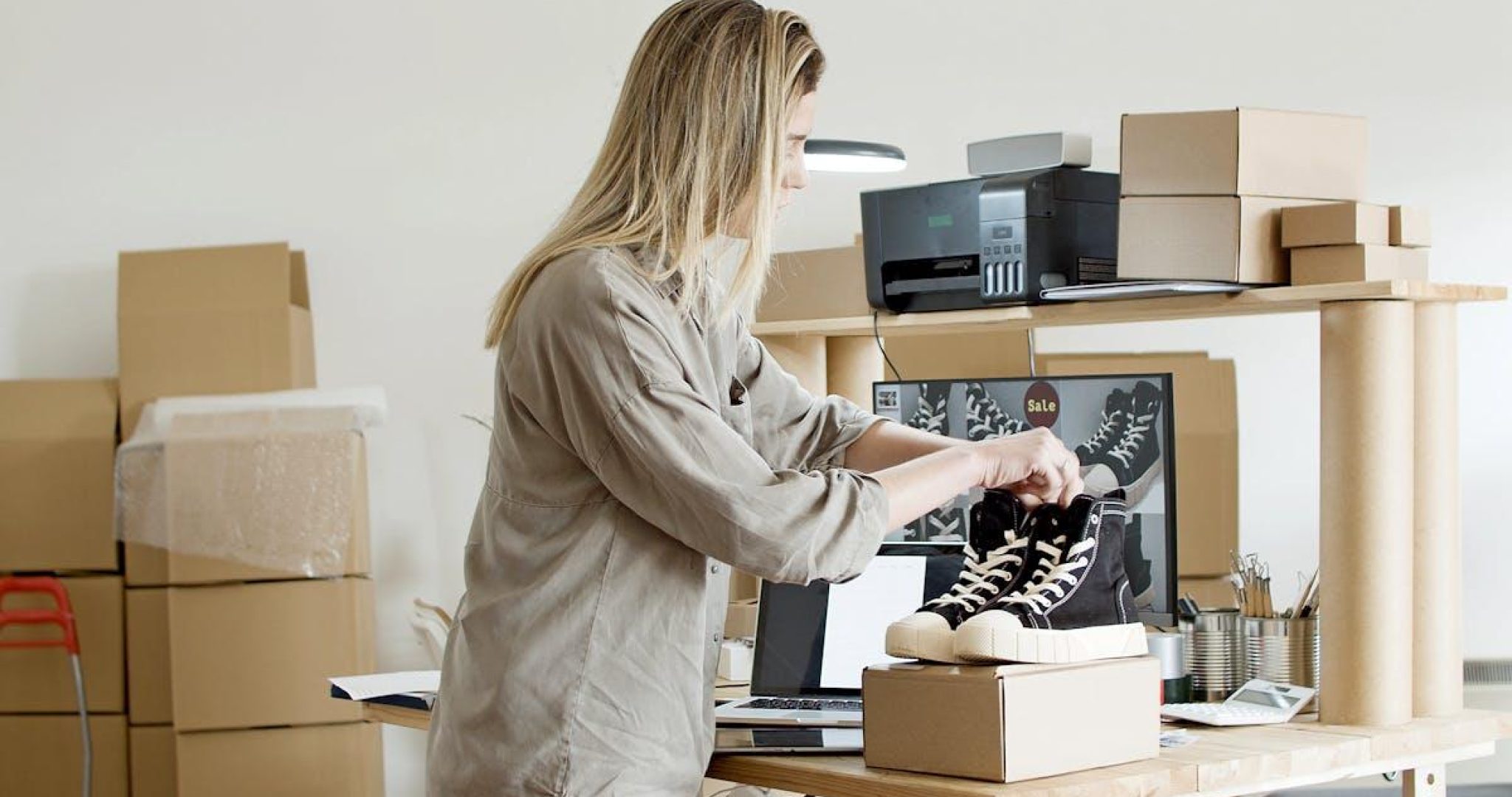 Business owner working at desk with laptop