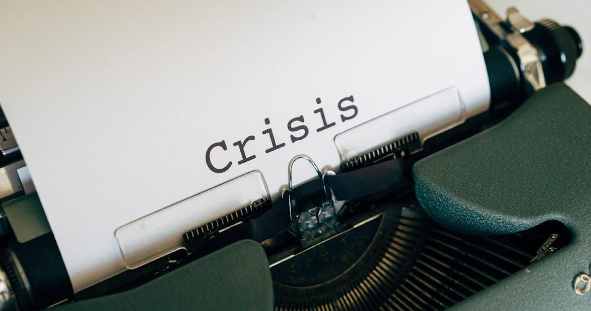 Vintage typewriter with the word Crisis