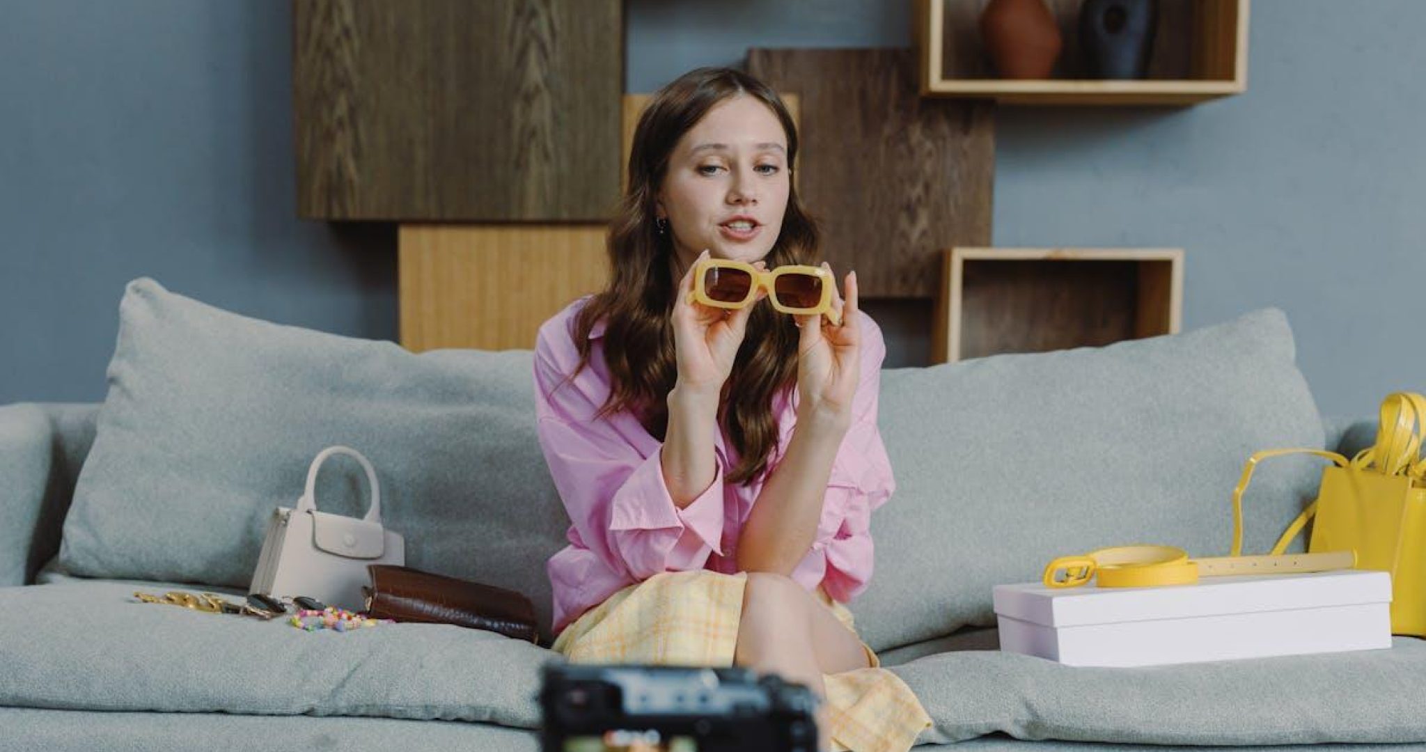 Young woman recording video blog content with smartphone