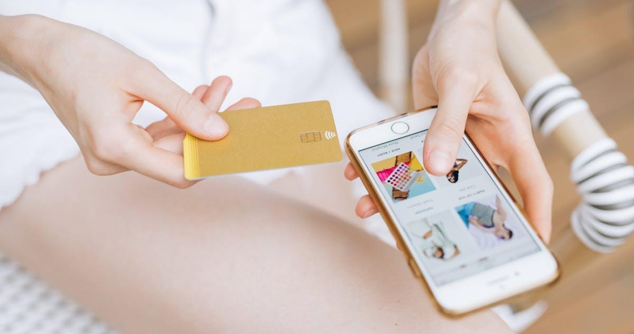 Woman using smartphone with credit card for online shopping, representing Instagram monetization and e-commerce