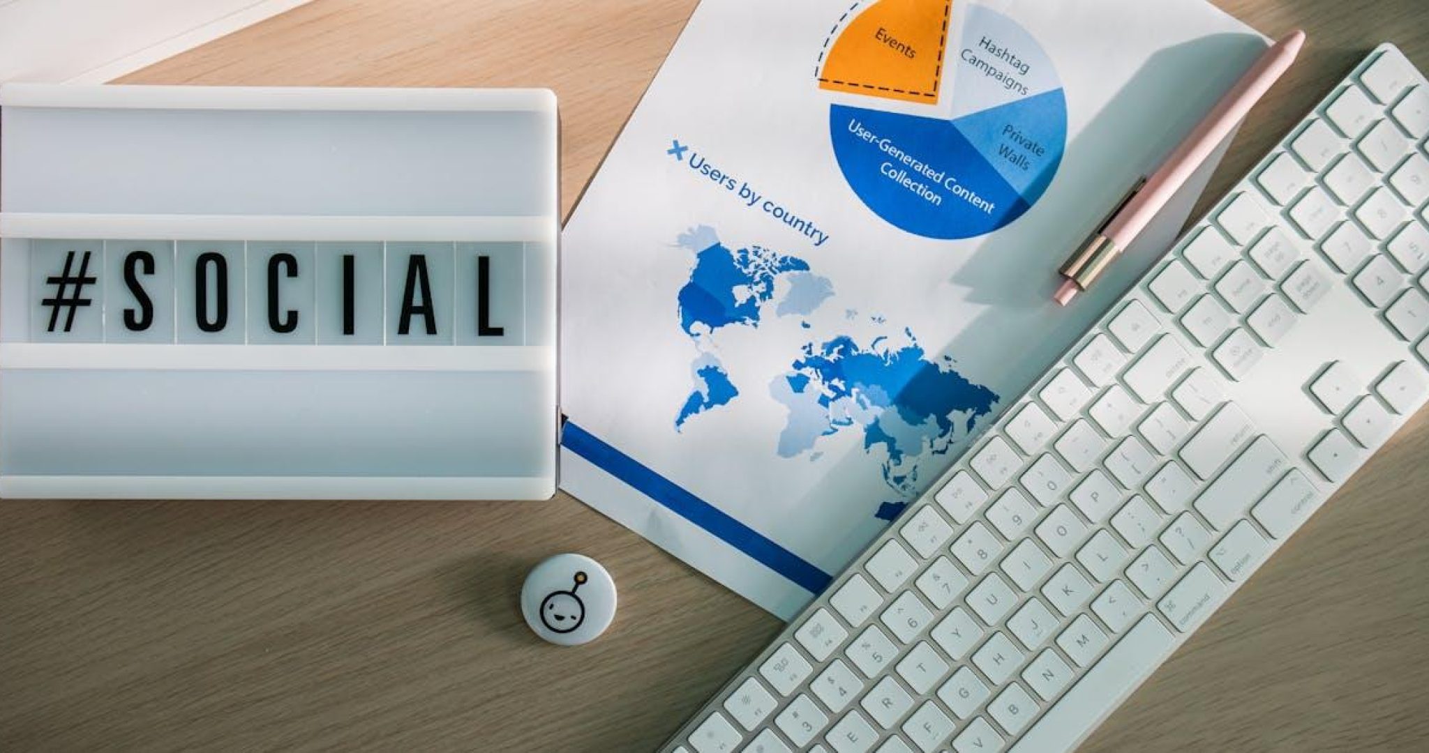 Desk with social media hashtag and analytics chart