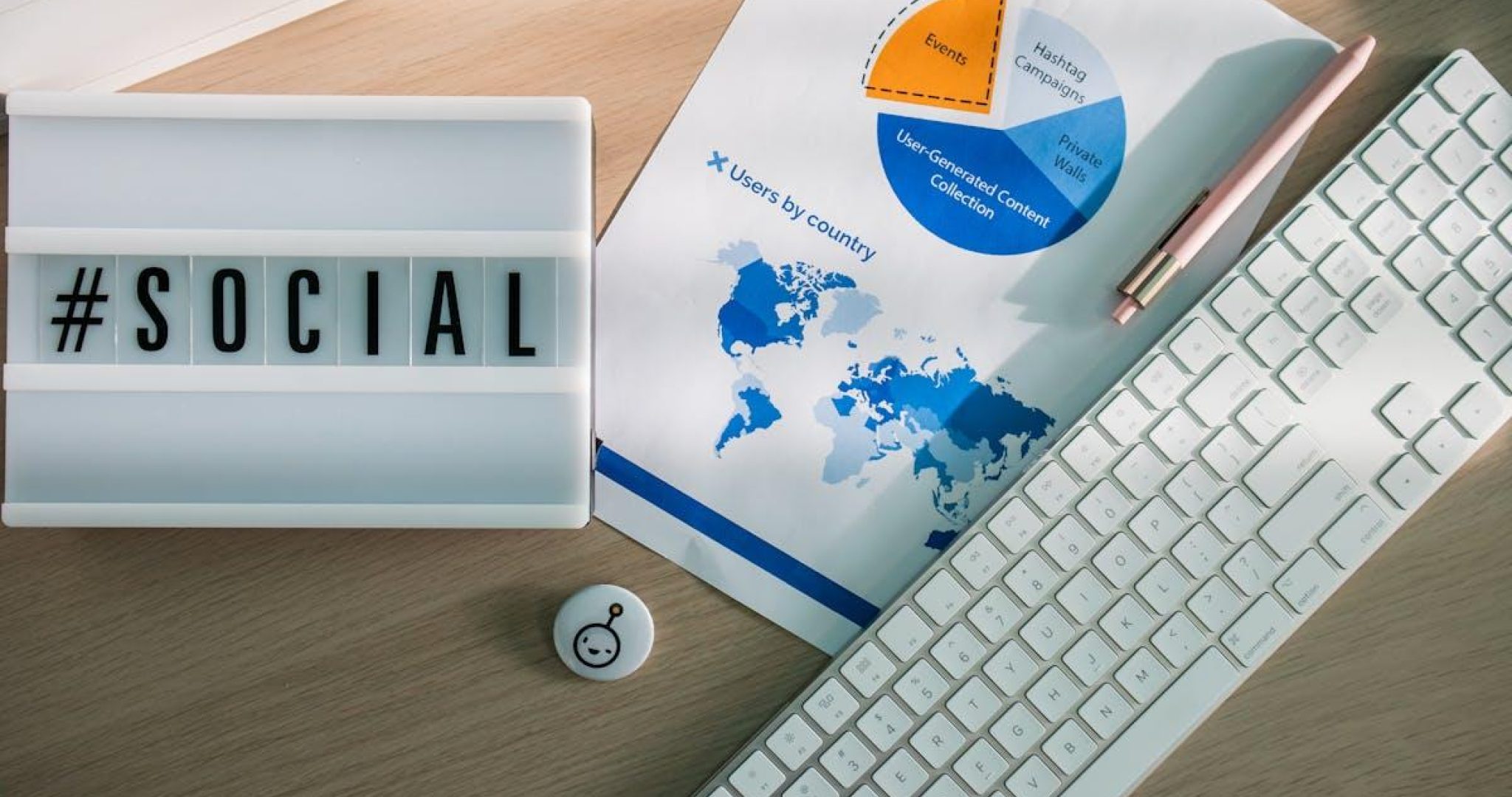 Desk with social media hashtags and analytics charts