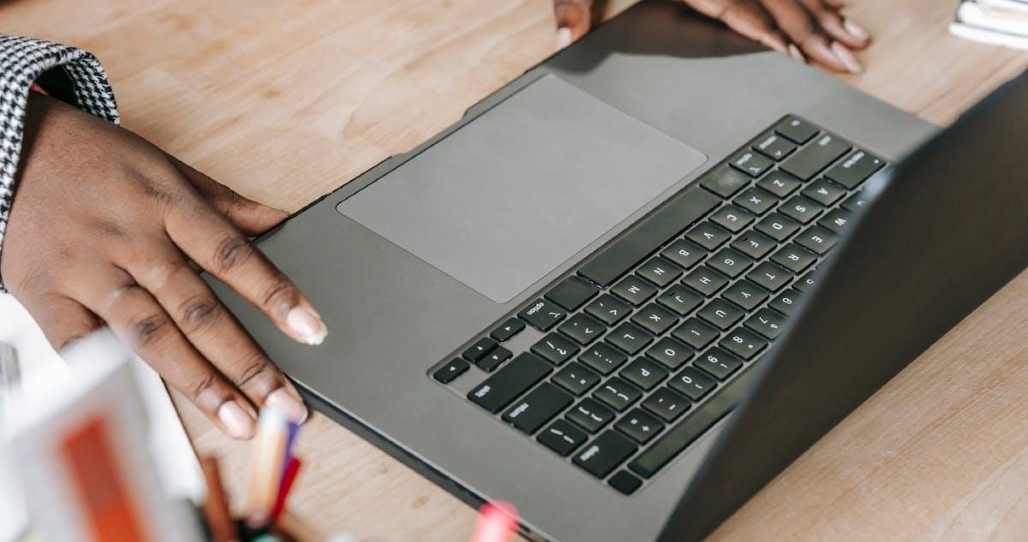 Professional social media specialist working on laptop at desk