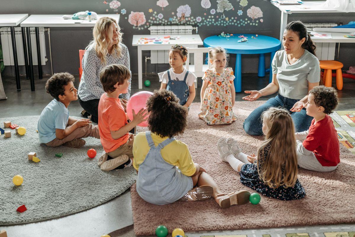 Children in circle time with teachers in a kindergarten classroom