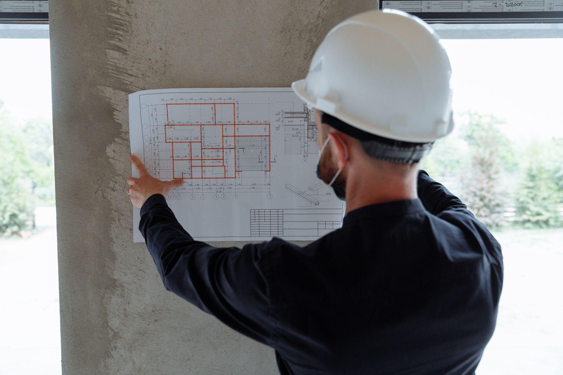 Contractor reviewing project plans on a construction site