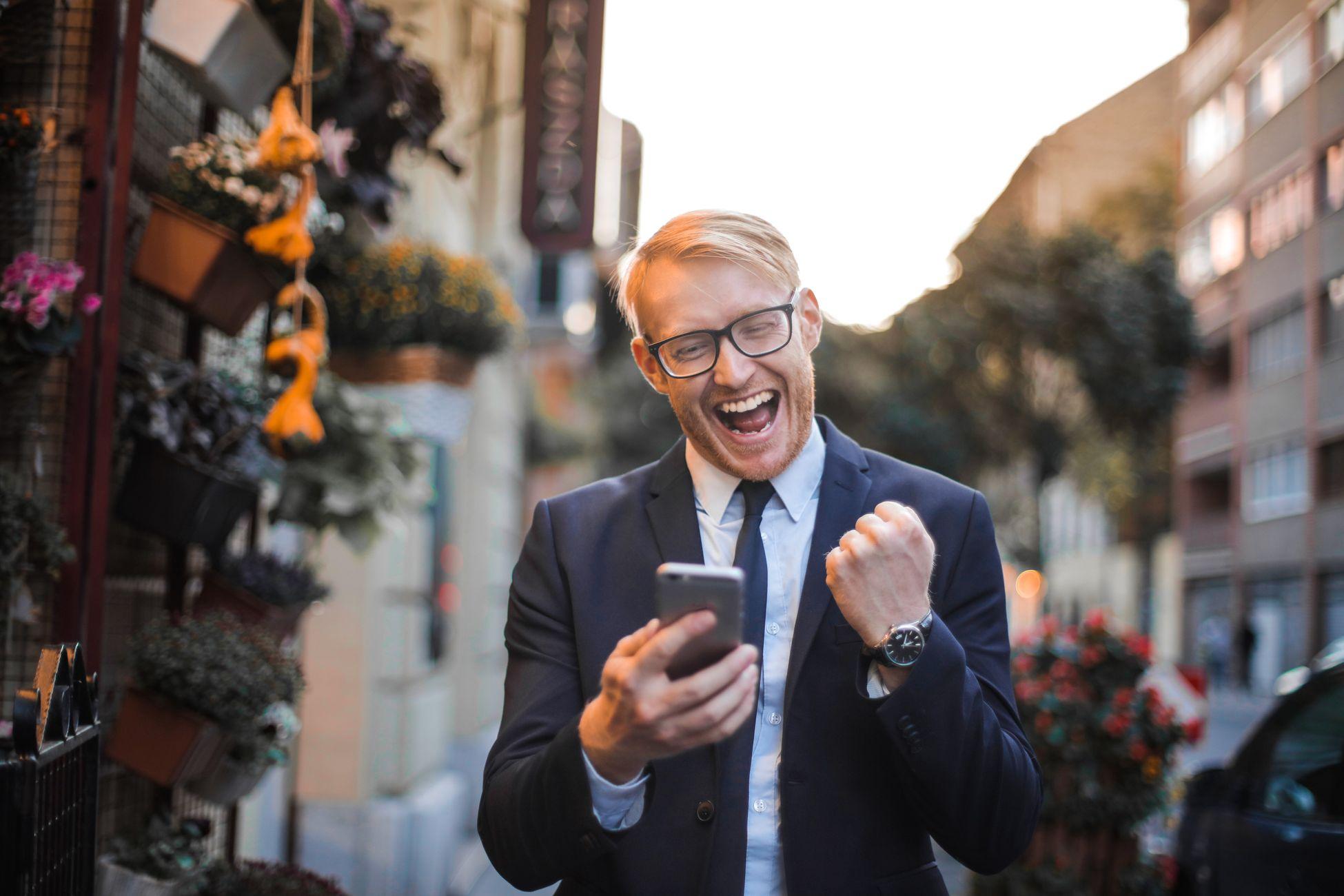 Man in suit using smartphone, representing social media engagement for professionals
