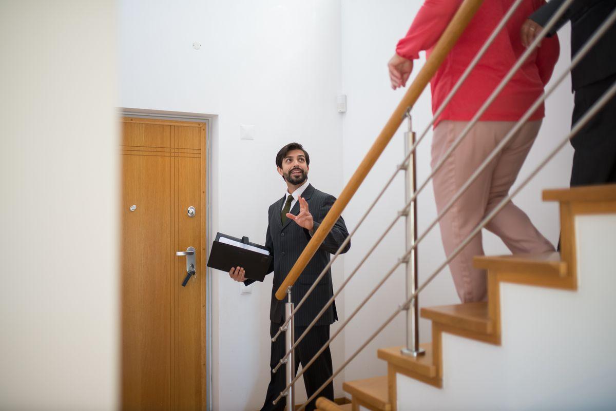 A realtor conducting a house tour with potential buyers