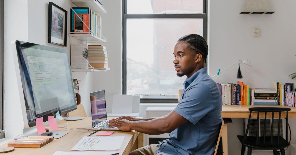Small business owner working on laptop in a modern office setting
