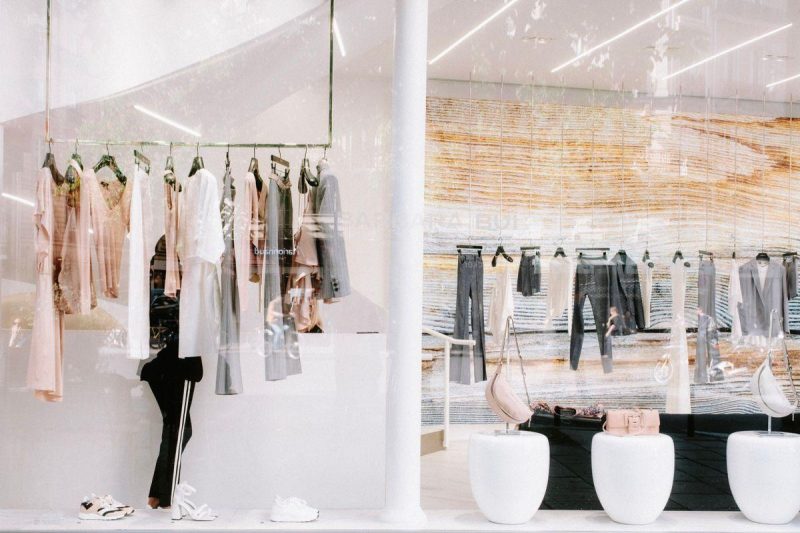 Fashion boutique interior with stylish clothing display on racks