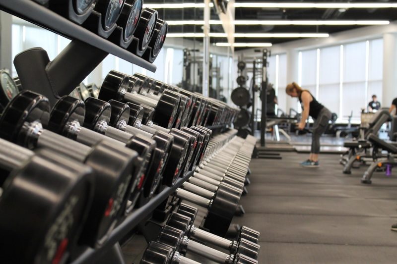 Person training with weights in a gym capturing the energy of a workout session