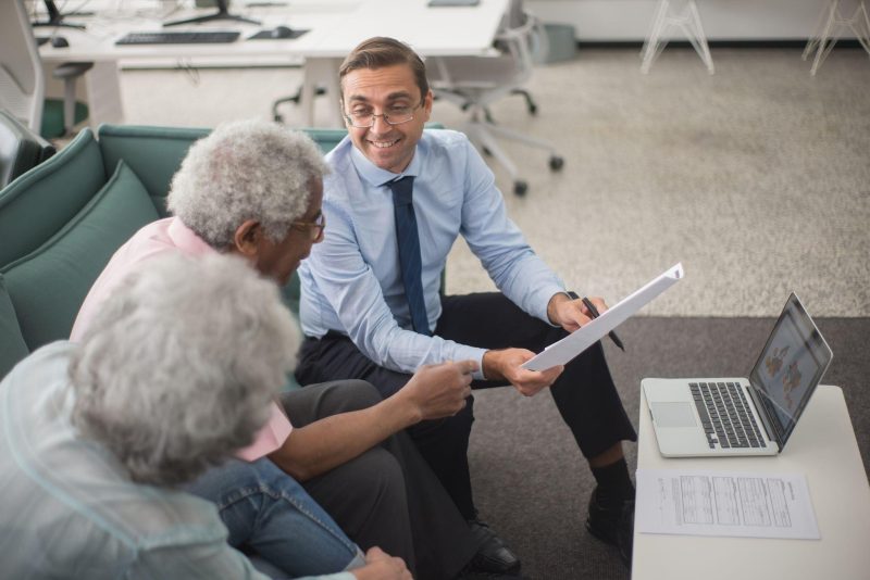 Insurance advisor discussing coverage options with clients at a desk