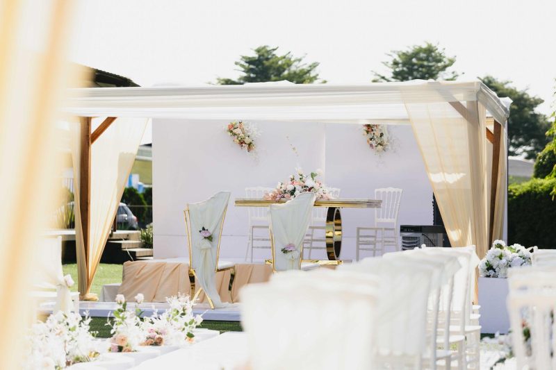 Beautiful outdoor wedding ceremony setting with white and pastel floral arrangements