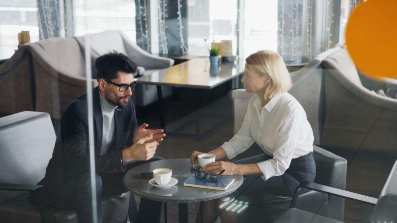 Business professionals discussing in modern office setting