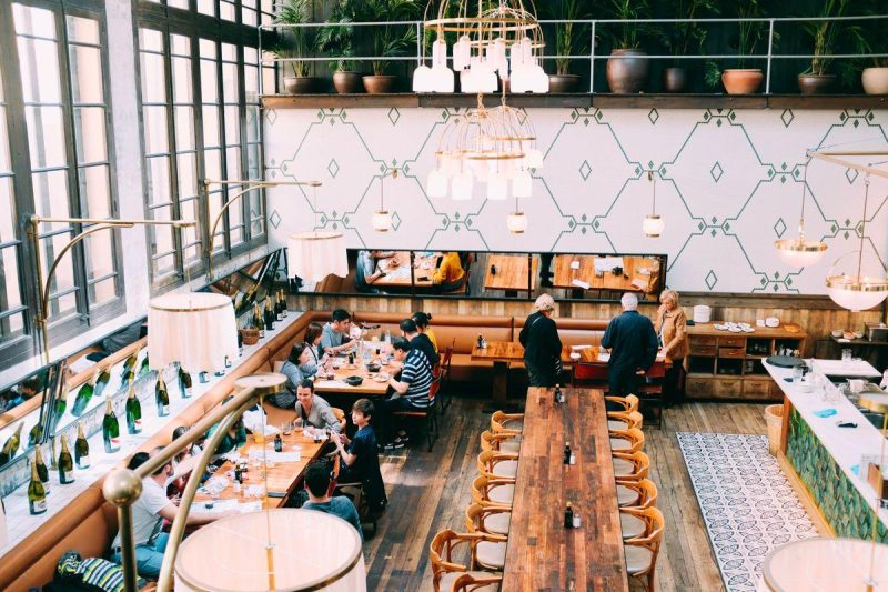Elegant restaurant interior with tables set for dining, warm ambient lighting