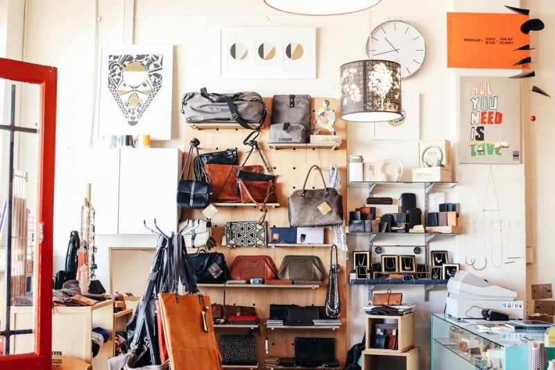 Retail store interior with assorted purses displayed on wooden shelves