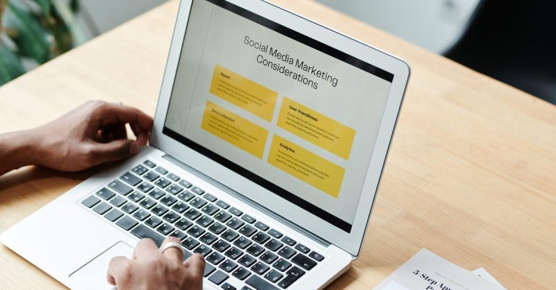 Business owner reviewing social media marketing strategy on a laptop