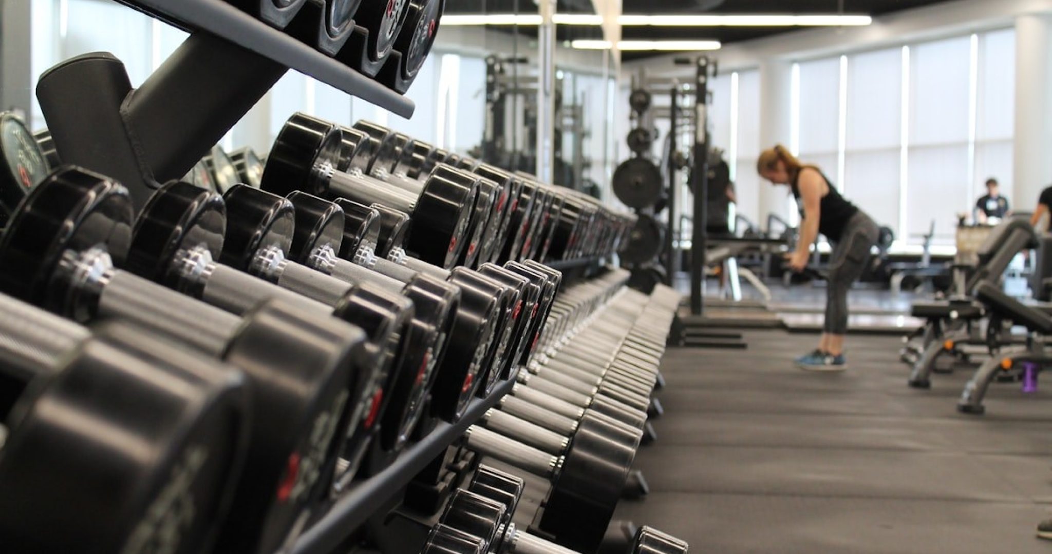 Person training with weights in a gym capturing the energy of a workout session
