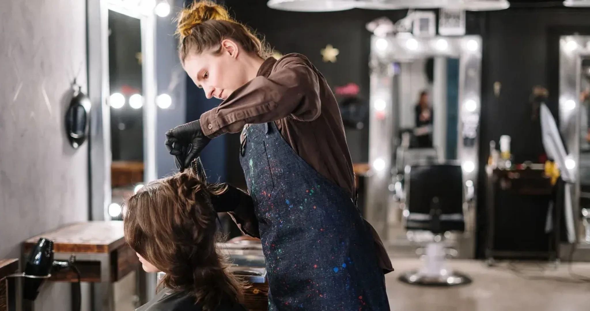 Hairstylist giving a client a haircut in a modern salon