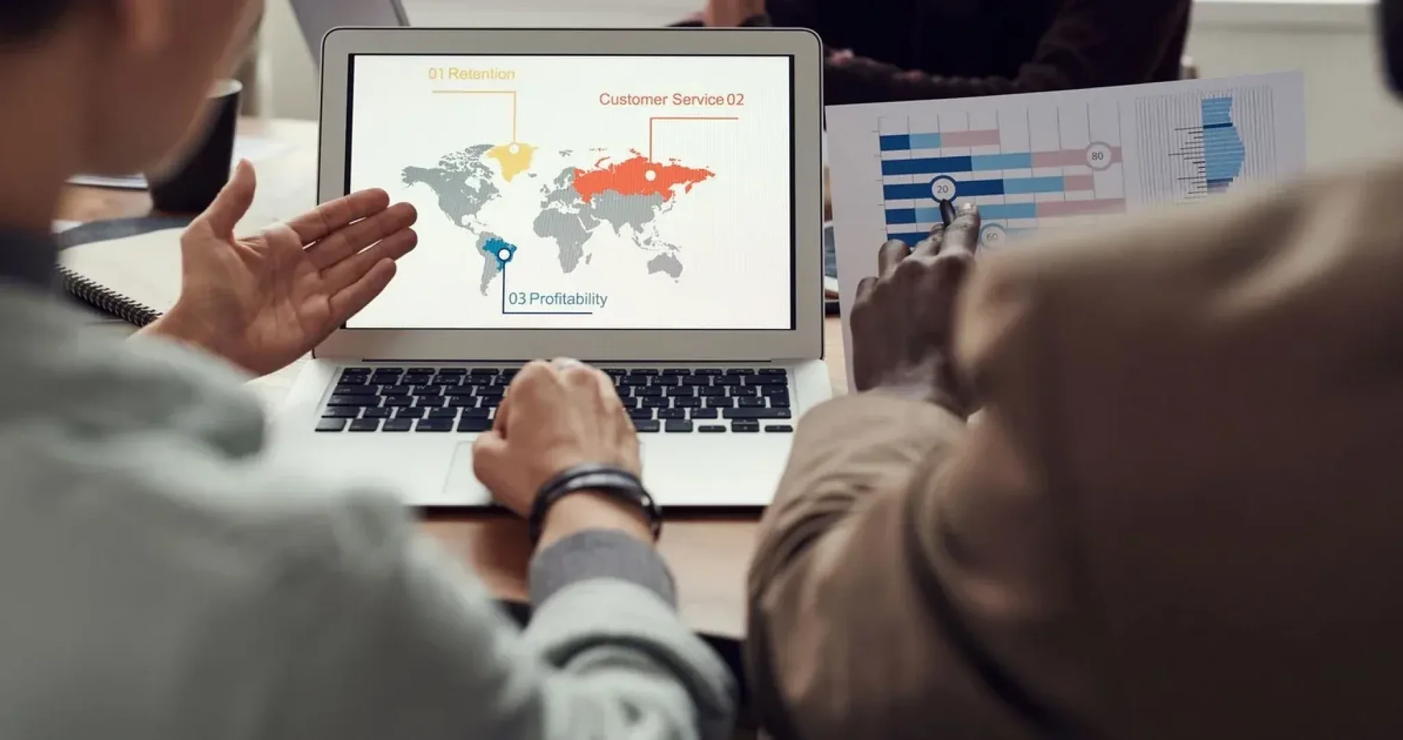 Marketing team reviewing social media campaign analytics together at a laptop