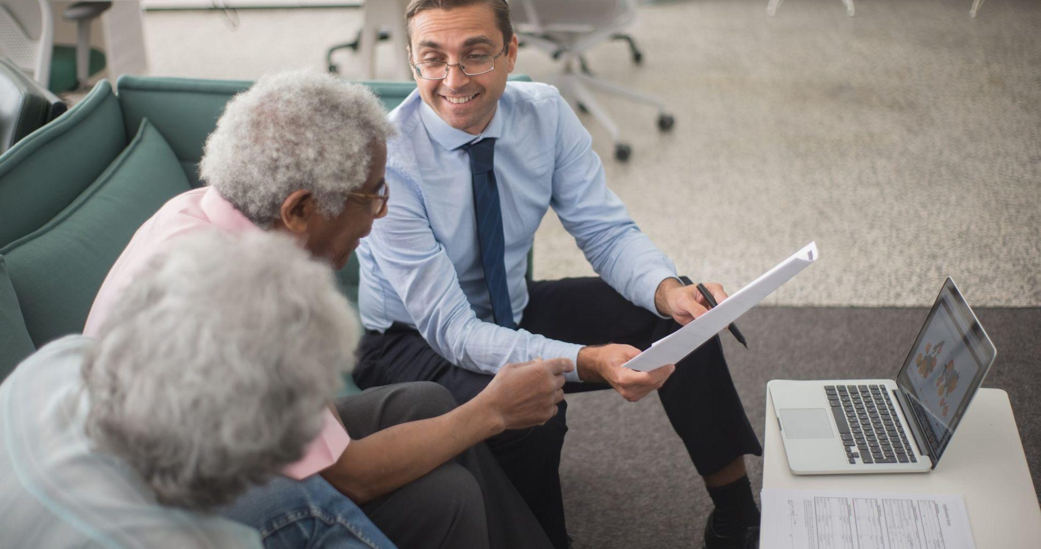 Insurance advisor discussing coverage options with clients at a desk