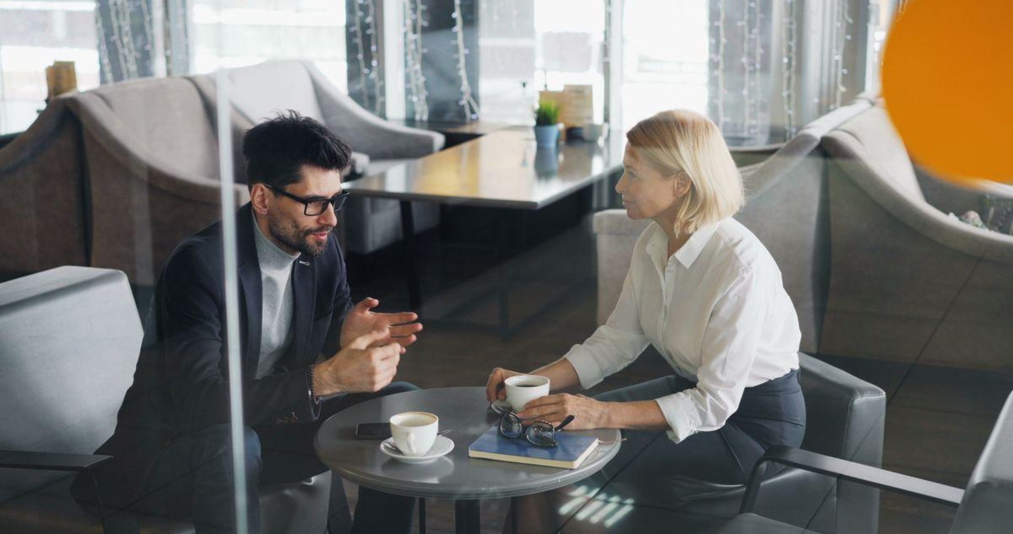 Business professionals discussing in modern office setting