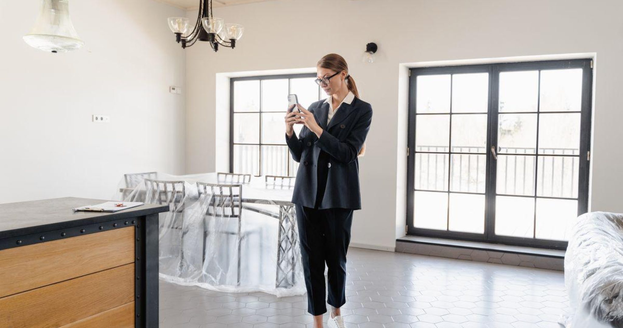 Real estate agent taking photos inside a bright modern apartment for social media