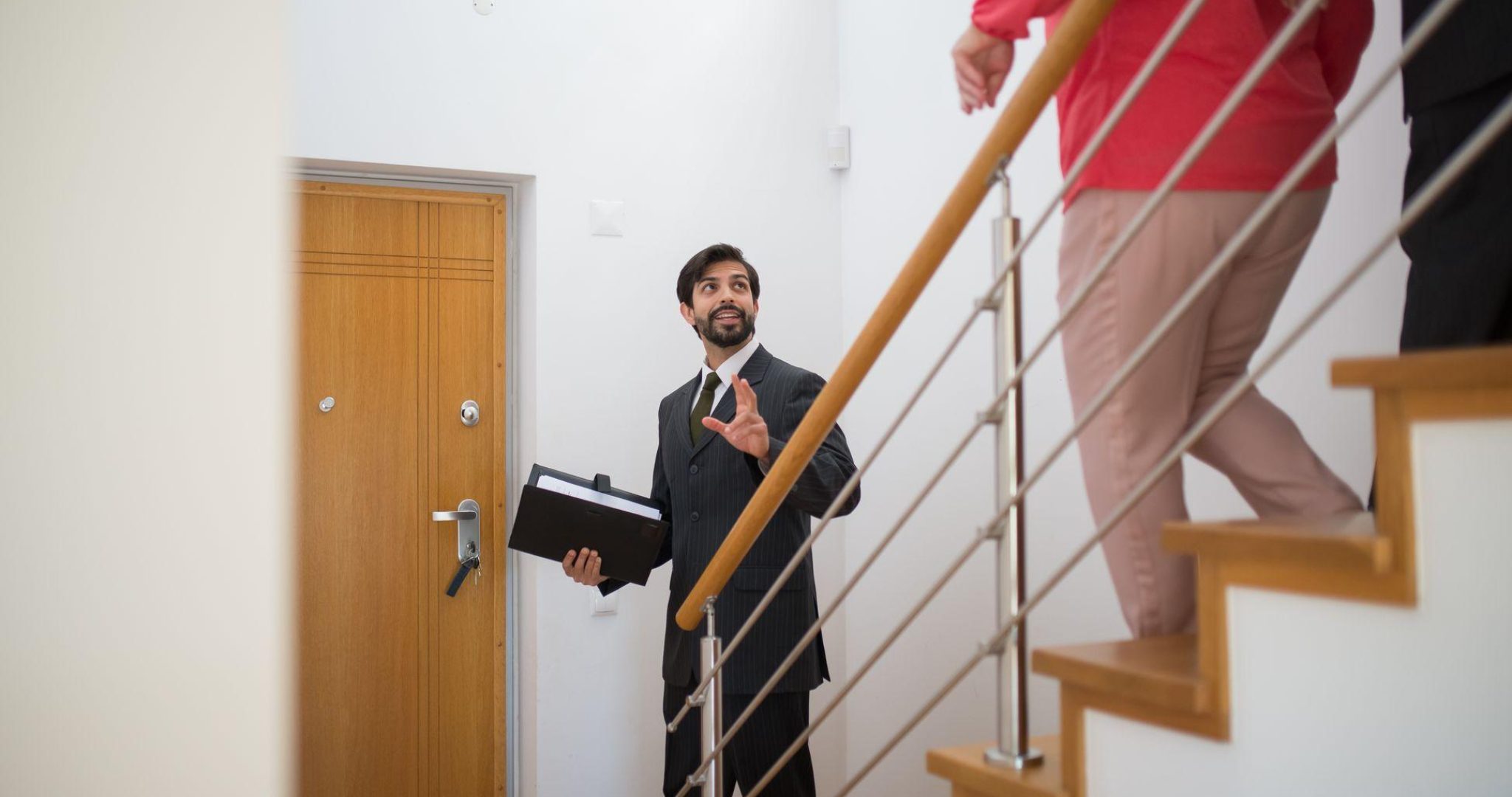 Real estate agent showing a modern home to potential buyers