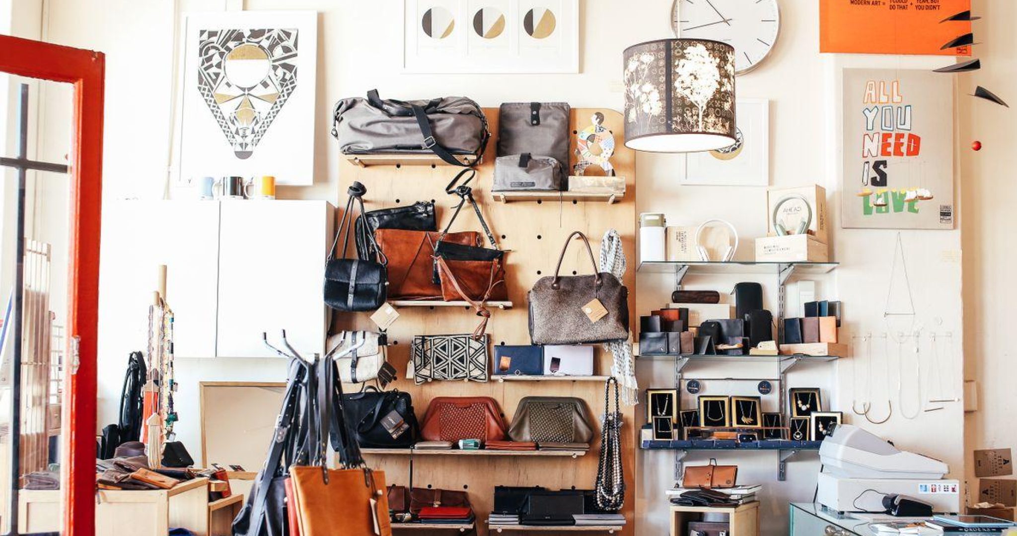 Retail store interior with assorted purses displayed on wooden shelves