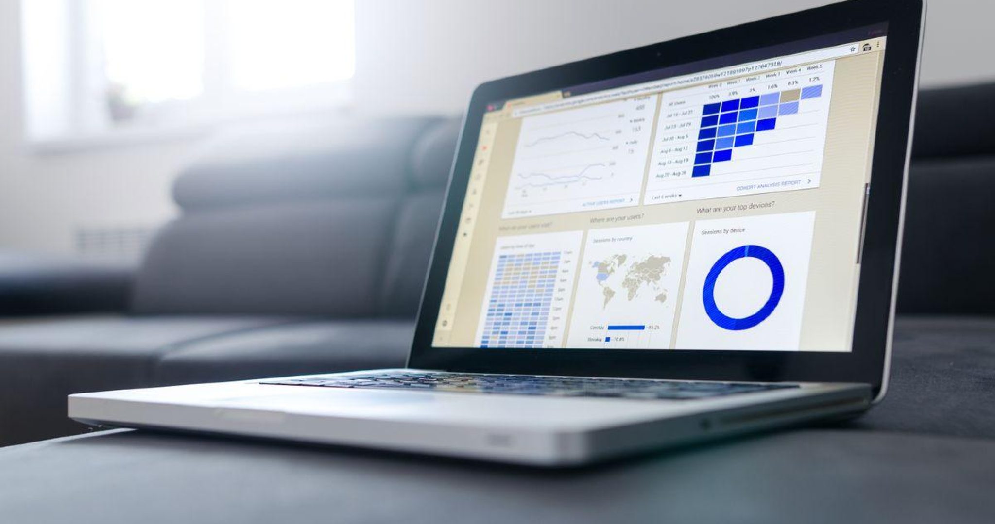 Laptop displaying social media analytics dashboard with charts and growth graphs