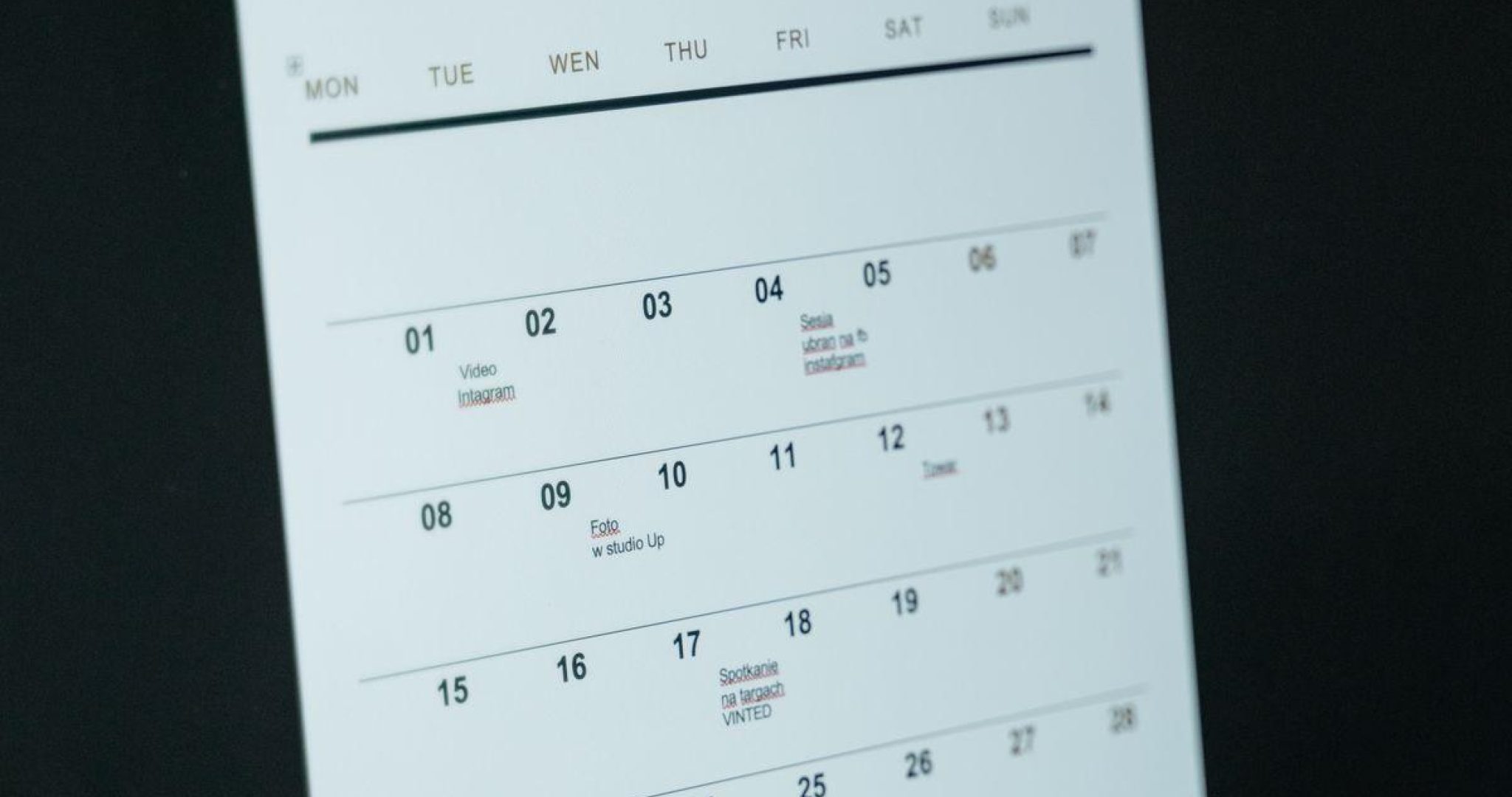 Close-up of a digital content calendar on a laptop screen, representing social media planning and scheduling