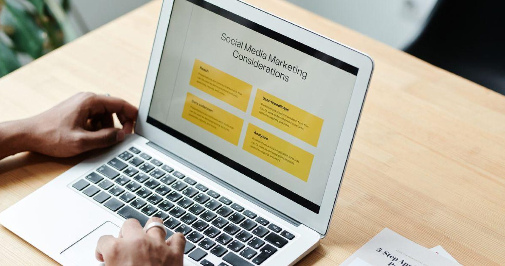 Business owner reviewing social media marketing strategy on a laptop