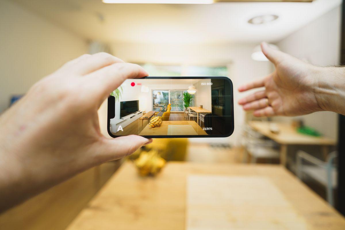Virtual property tour on a smartphone showing a contemporary living room